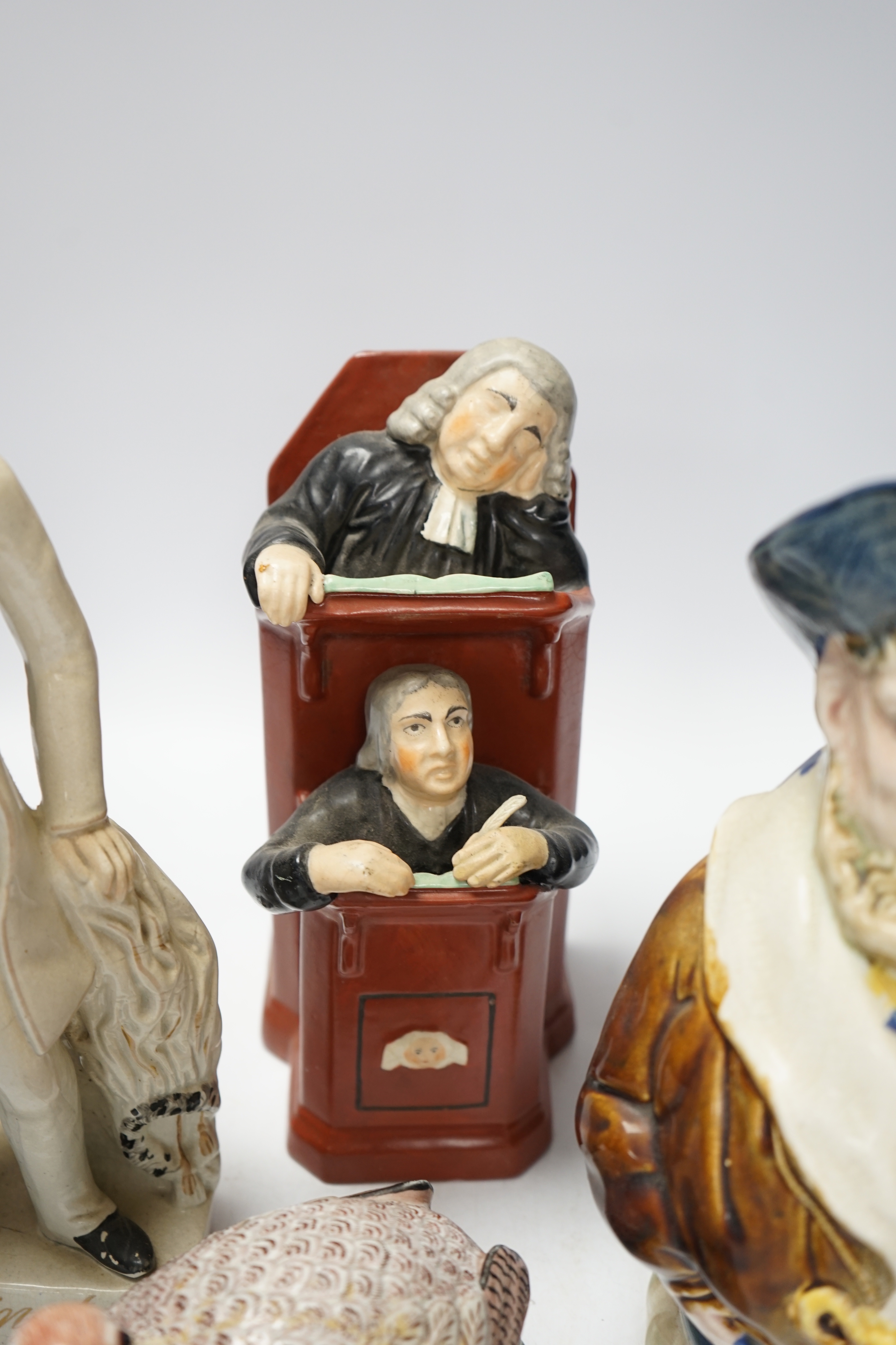 A Staffordshire figure of Wellington, a majolica sailor jug and a Vicar and Moses group, largest 32cm high